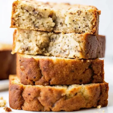 Easy banana bread recipe sliced thick showing moist texture with visible nuts and chocolate chips