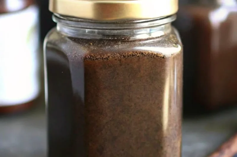 Glass jar filled with homemade vanilla bean paste, used as a natural flavoring in baking and desserts.