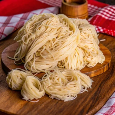 Kataifi recipe with shredded filo dough, filled with nuts, and drizzled with sweet syrup – a traditional Middle Eastern dessert.