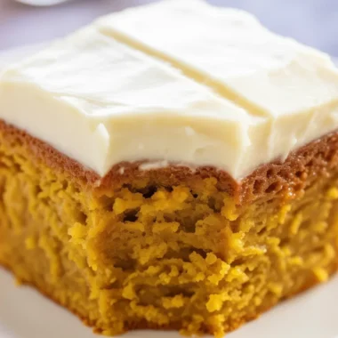 Moist pumpkin spice cake with cream cheese frosting, perfect for fall celebrations.