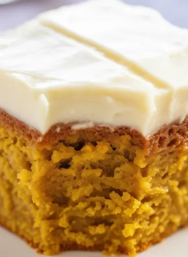 Moist pumpkin spice cake with cream cheese frosting, perfect for fall celebrations.